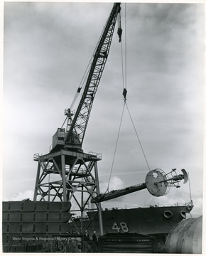 The mast of the U.S.S. West Virginia being loaded at Todd Shipyards in Seattle, Washington. The mast was shipped to Morgantown, W. Va. in February 1961.