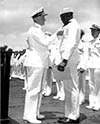 Admiral Chester Nimitz awards Dorie Miller the Navy Cross.