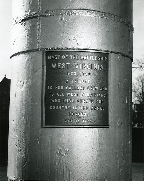 Dedication plaque on the mast of the USS <em>West Virginia</em> on the campus of West Virginia University.