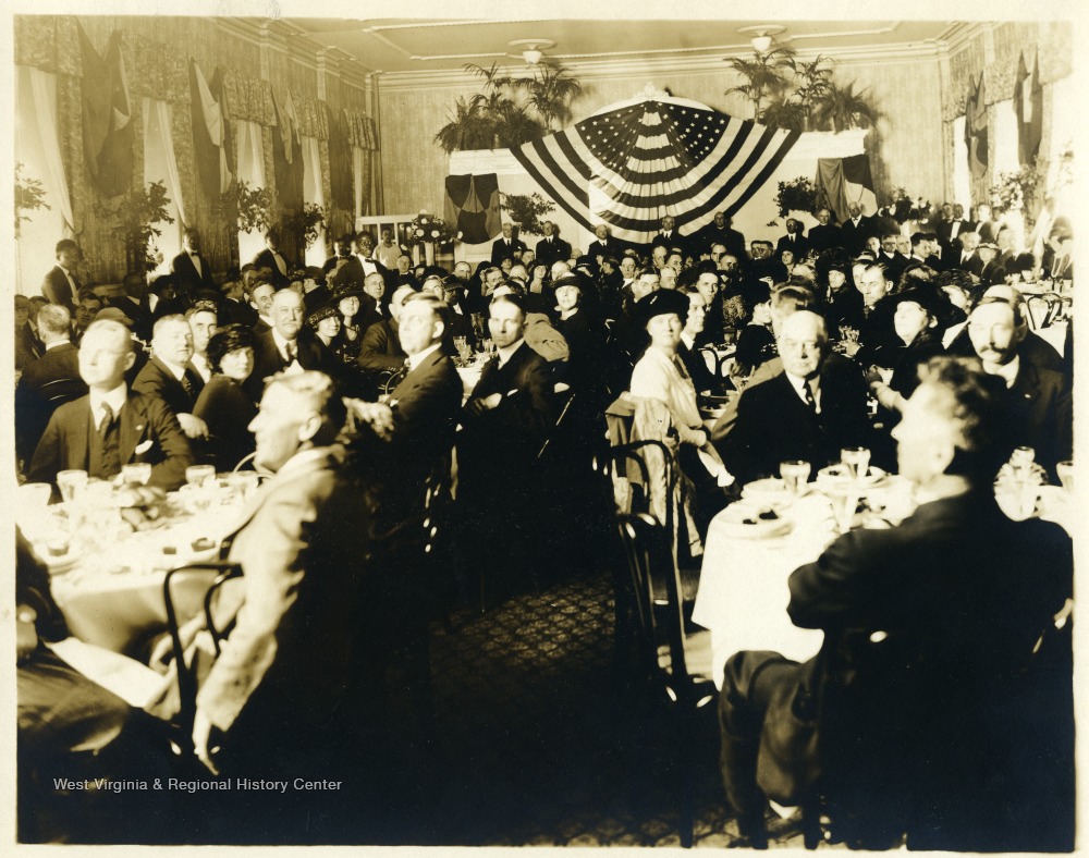 Men and women dining in celebration of the U.S.S. West Virginia.