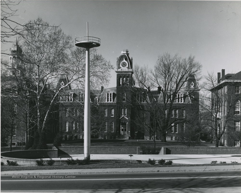 Woodburn Circle is pictured in the background. The mast is erected in Memorial Plaza, which is located directly in front of Oglebay Hall. 