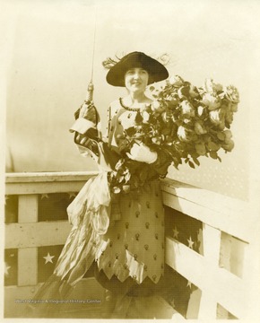 Portrait of Alice Wright Mann holding a bouquet and a bottle before the christening of the U.S.S. West Virginia.